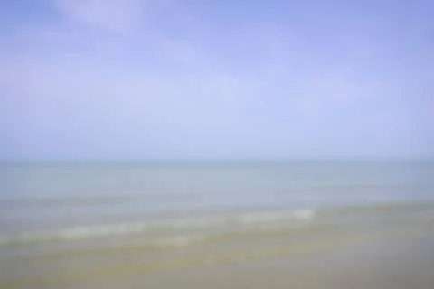 View of a sandy beach during the day with a blue sky background Stock Photos