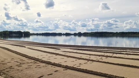 View at a sandy beach at a lake with some strange patterns in the sand Stock Footage 348610625