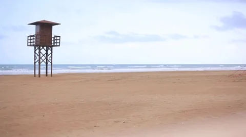 View of a sandy beach with life guard tower in Cullera background Stock Footage 47865087