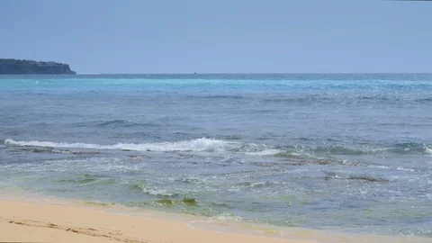 View from a sandy beach on a sea with huge waves and vivid blue water Video stock 114991292