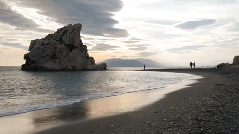 View of a sandy beach before sunset with a big nice rock Stock Footage 119036441
