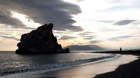 View of a sandy beach before sunset with a big nice rock. Stock Footage 119110929