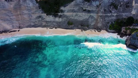 View on sandy beach under cliff with azure water Stock Footage 159640108