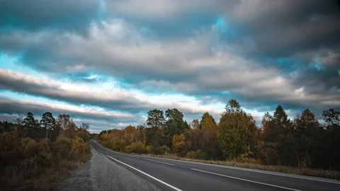 View on the scenic road surrounded by the beautiful colorful forest during a Stock-Footage 161817132