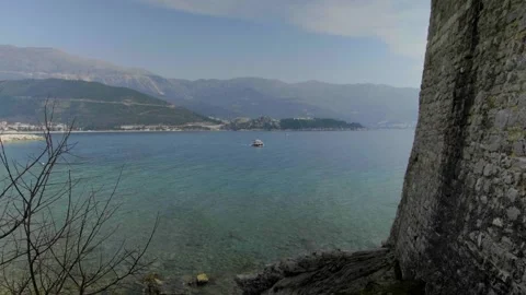 The view of the sea and mountains through tree branches from the old town. Stock Footage 295783451