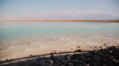 View of the sea beach at daytime. Mountains are far away. Dead sea near Ein Stock Footage 183406073
