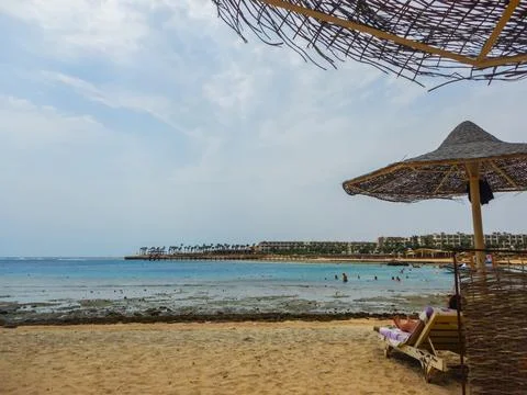View to the sea from the beach while lying under a beach umbrella Stock Photos