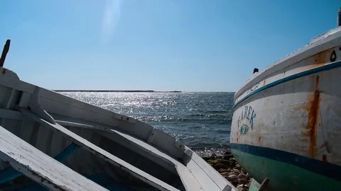 View of the sea behind two fishing boats Stock Footage 80295331