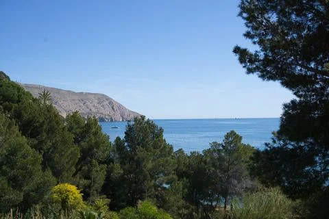 View of the sea between vegetation, located in Alicante, Spain Stock-Fotos