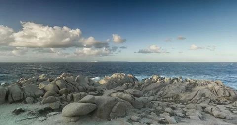 View of the sea from Capo Testa through the rocks, time lapse, 4K. 動画素材 120411629