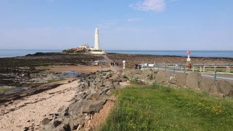View Of The Sea Coast With A Lighthouse At Low Tide In Calm Weather Stock Footage 281961713