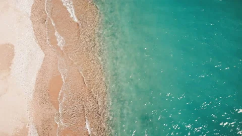 View of sea coast from the top. Small waves, transparent water. Footprints on Stock Footage 145168646