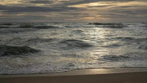 View of the sea illuminated by the rays of the setting sun. Stock Photos
