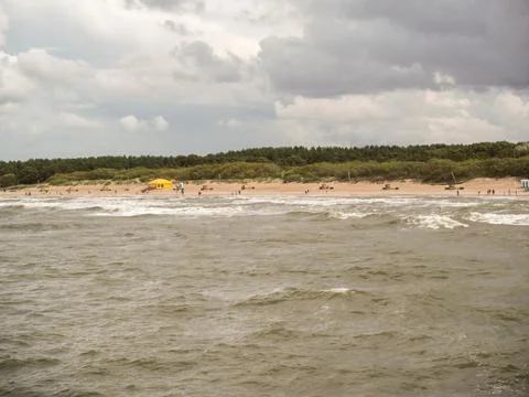 View from the sea to the sandy beach. Stock Photos