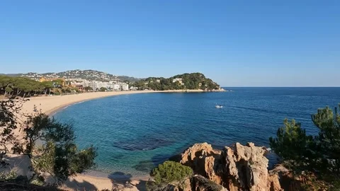View of sea shore with calm waves, clear blue sky and some greens Stock Footage 169100249
