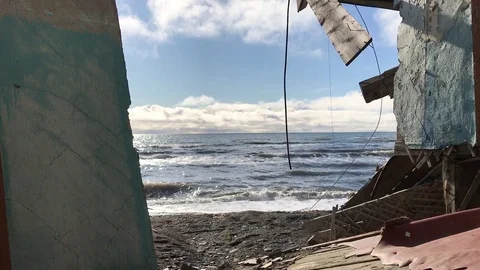 A view of the sea shore through an old ruined house. Stock-Footage 80089352