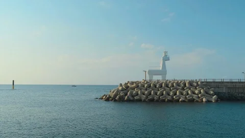 The view of the sea at sunset, with the sky and the sea and a huge breakwater an Stock Footage 119506536