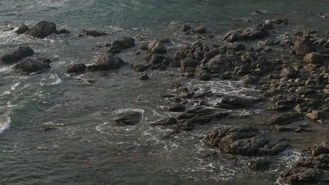 View of sea tide wave splashing against rock shore. Stock Footage 88876314