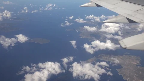 View of sea water and island coastline from airplane air plane journey sunny day Stock Footage