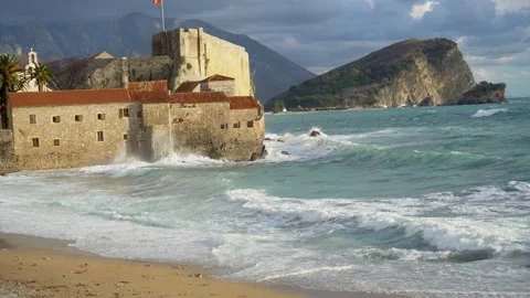View sea waves on the beach, old town of Budva in the background Stock Footage 85585939