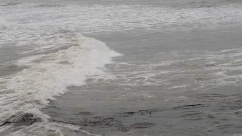 View of sea waves containing white foam striking sea shore Video stock 191394553