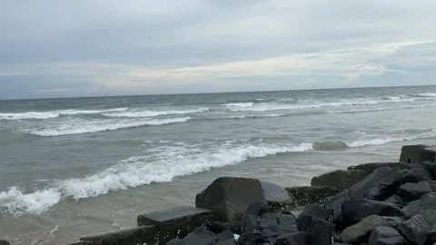 View of sea waves hitting rocks on the beach Stock Footage 164237879