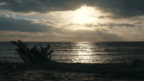 A view of the sea with waves, the rays of the sun through dark clouds. Dramatic Stock Footage 91495467