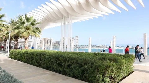 View of a seafront promenade with tourists passing by. Stock Footage 106338189