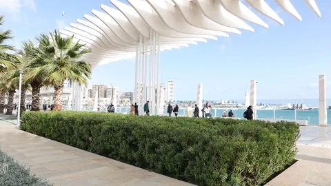 View of a seafront promenade with tourists passing by. Stock Footage 106338192