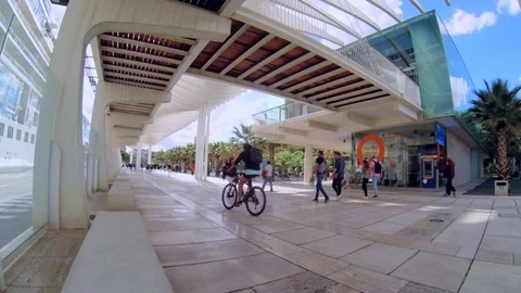 View of a seafront promenade with tourists passing by Stock Footage 108401801
