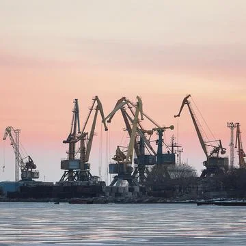 View on seaport with cranes at sunset Stock Photos