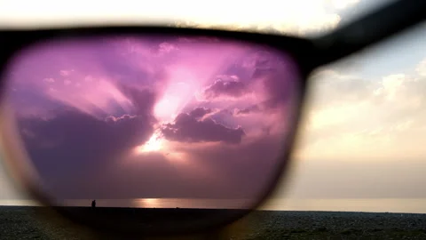 View on seascape sea and sunset sky through polarizing purple sunglasses. Stock Footage 245986302