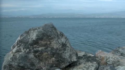 View of the seaside behind a rock Stock Footage 86294686