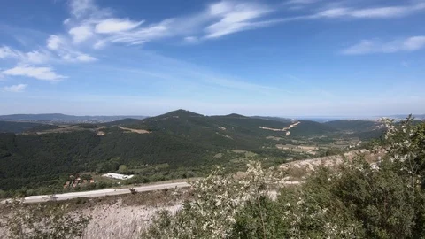 View of seaside karst landscape covered with forest trees on sunny day Stock Footage 130071536