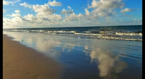 View of the seaside, reflection of the sky in the water on the beach Stock Footage 259304475
