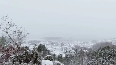 View of a seaside village while snow is falling Stock Footage 146902205