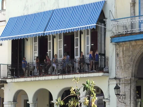 View to second floor of cafe summer terrace with big awning from the sun on Stock Footage 69759910