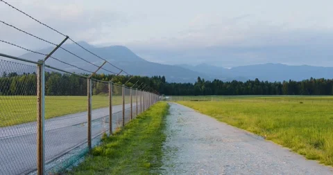 View of security barb wire fence, Ljubljana airport, Slovenia Stock Footage 156663569