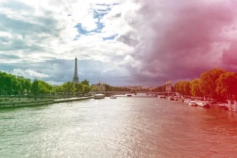 View of the Seine river with Eiffel tower in the background, with dramatic skies Stock Photos