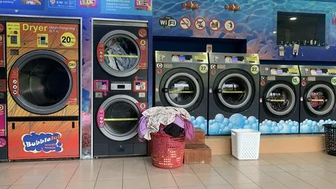 View of a self-service laundry machine, selangor-Malaysia July 7th 2024 Stock Photos