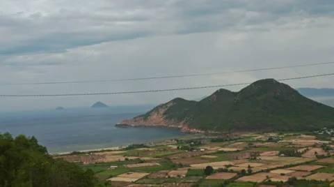 View of Separated Rural Peasant Fields against Sea Hill Stock Footage 66855431