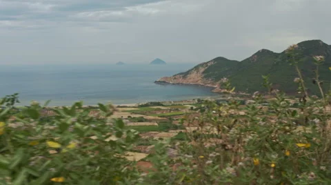 View of Separated Rural Peasant Fields against Sea Hill Stock Footage 66855443
