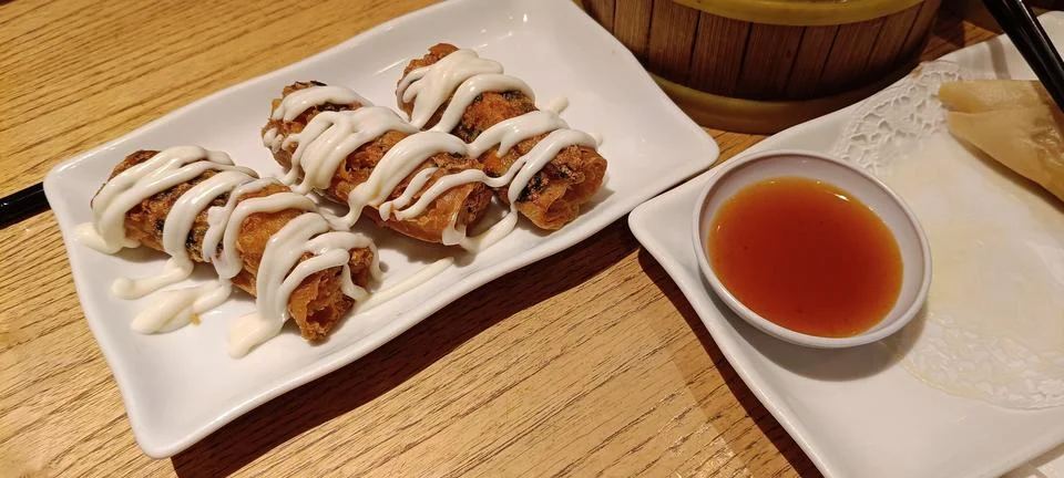 View of a serving of crispy fried spring rolls Stock Photos