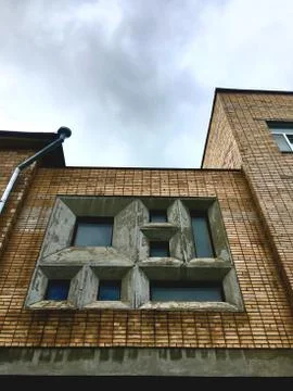 View of a set of square windows. Old Soviet building. background yellow brick Stock Photos