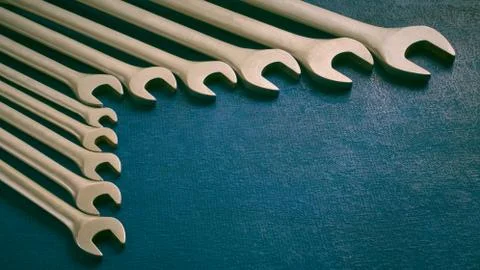 View of set of various work spanner on dark background, stylized, shallow dep Stock Photos