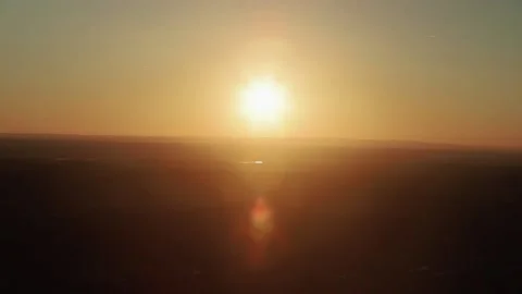 View of setting sun with lens flare over Portuguese landscape from Monsaraz Stock Footage 160811052