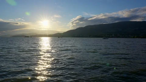 View of the setting sun over the sea horizon from the top a hill Stock Footage 157249436