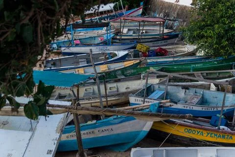 View of several fishing boats docked on the sands of Rio Vermelho beach in .. Stock Photos