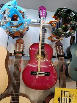 View of several musical instruments hanging on the wall Stock Photos