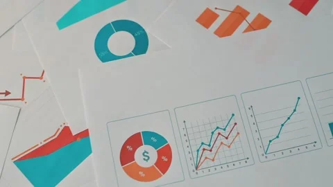 View several sheets of paper with various charts and graphs are spread across a Stockbeeldmateriaal 338302454